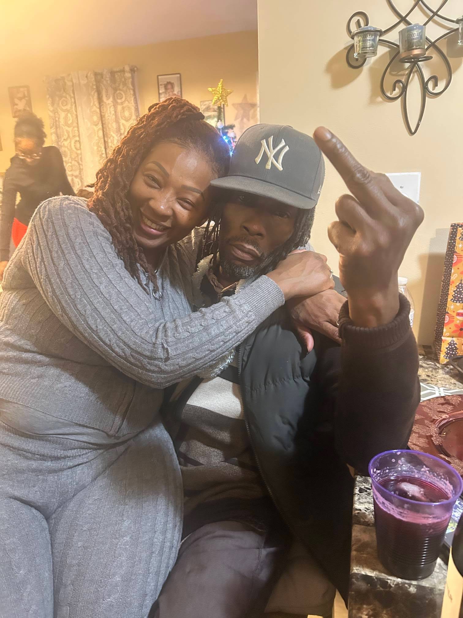 MINDBENDA with a woman in a gray sweater indoors near a Christmas tree