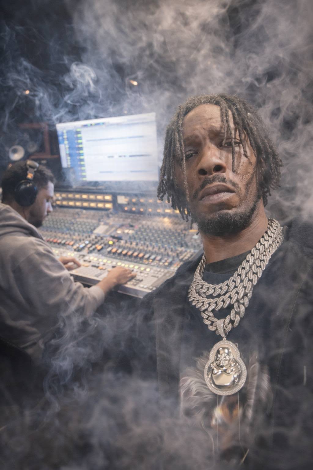 MINDBENDA with layered chains in a smoky studio, engineer at the console